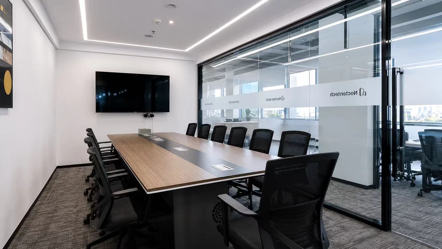 Modern glass meeting room at the Nocten Tech office